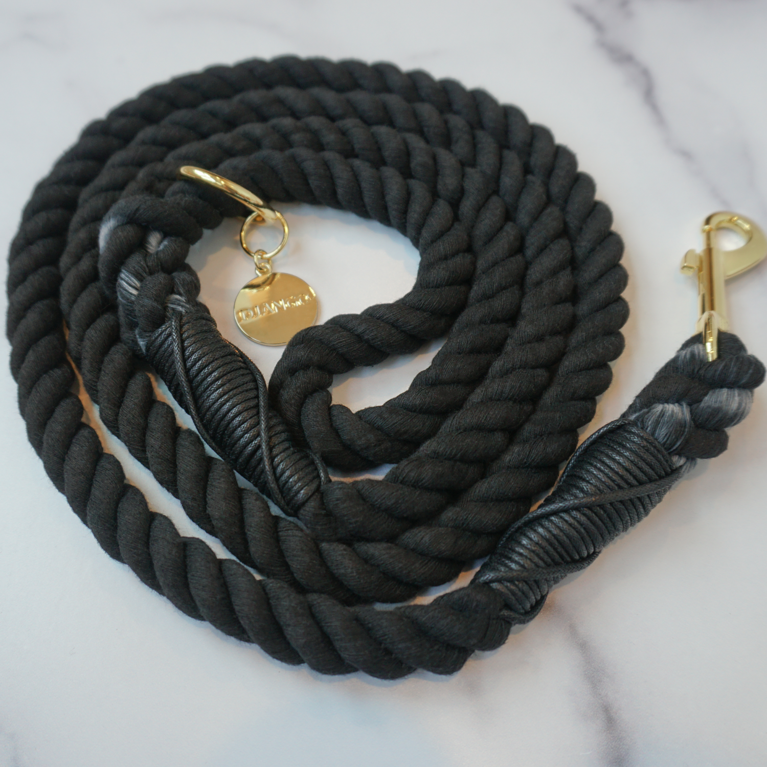 Soft yet sturdy black cotton rope leash offers control and comfort for small to large dogs.