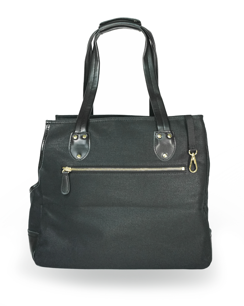 Backside of black dog carrier purse showing soft leather handles and trims and large zipper pocket with gold hardware