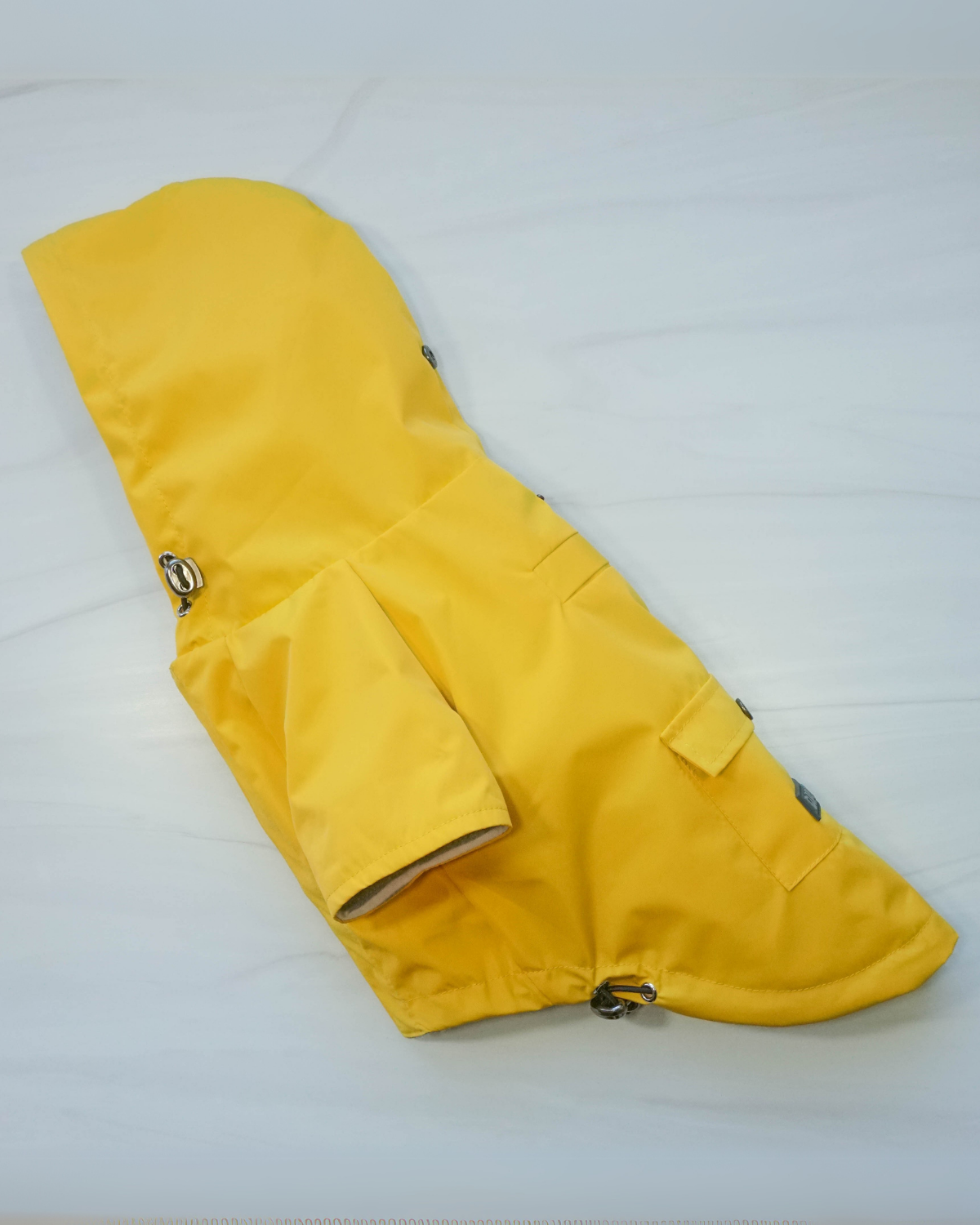 This yellow dog raincoat is stylish, wahsable, and made to last. Use the hooded dog raincoat for small dogs in summer rain showers and for autumn and winter walks.