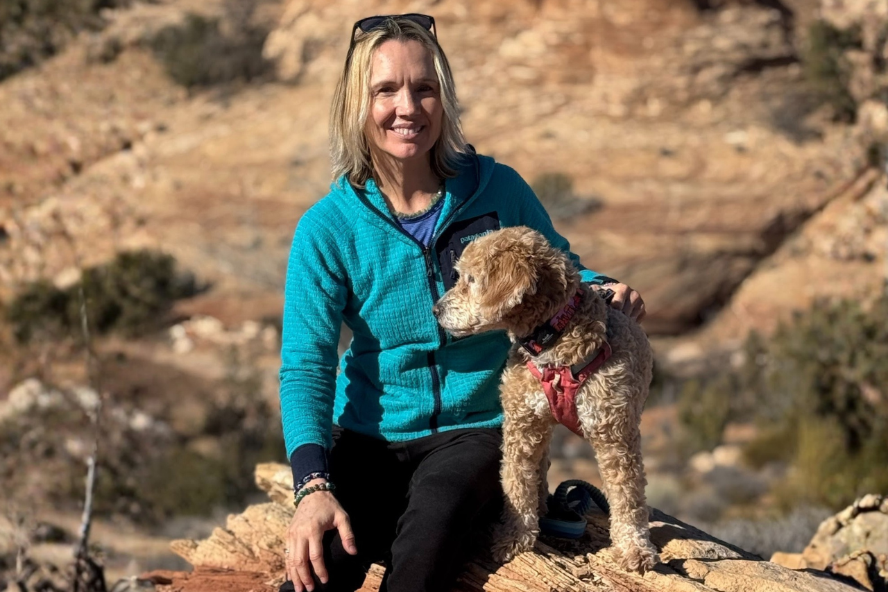 Dr. Krista Halling with her dog River during an outdoor adventure in a rocky landscape