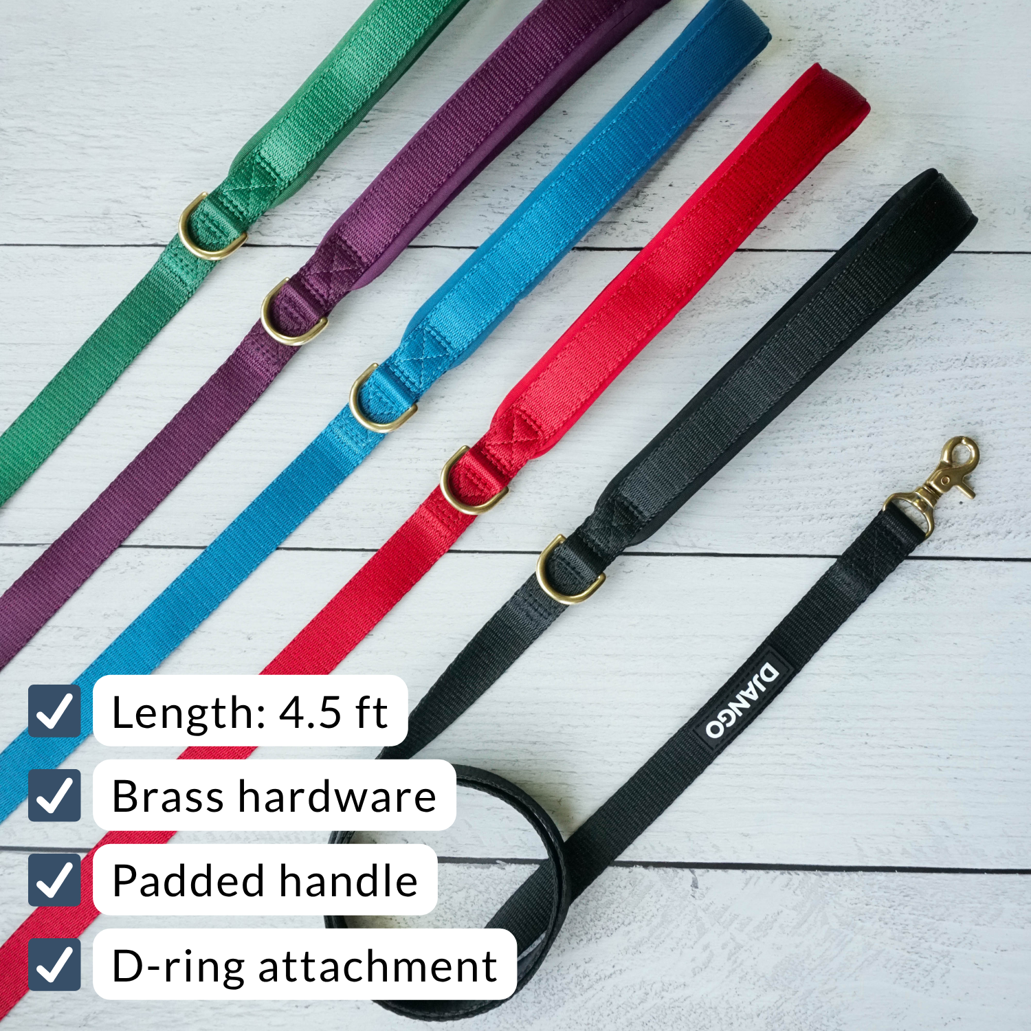 Set of colorful dog leashes with brass hardware on a white wooden surface