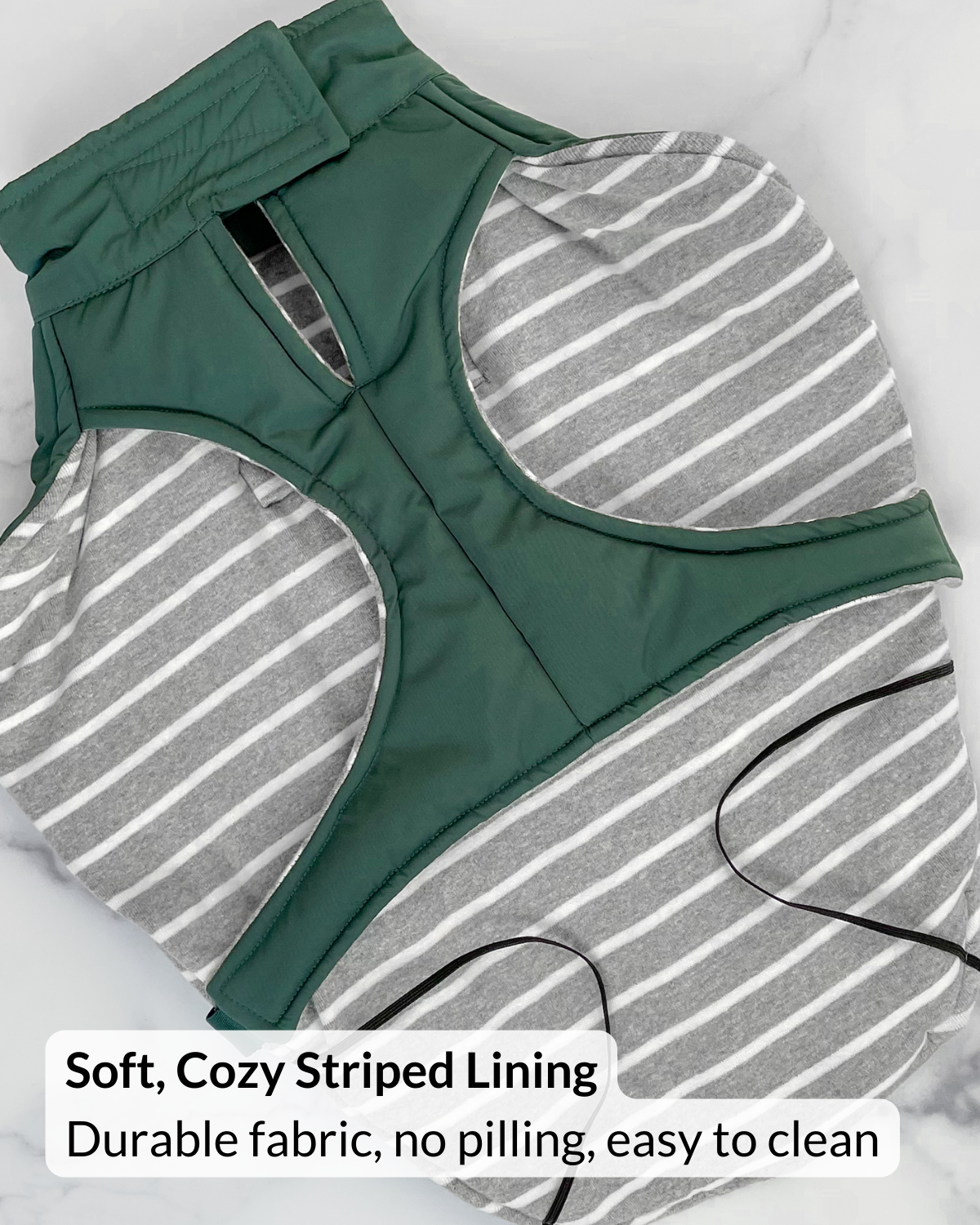 Green puffer dog coat with striped lining of pet coat on a white background