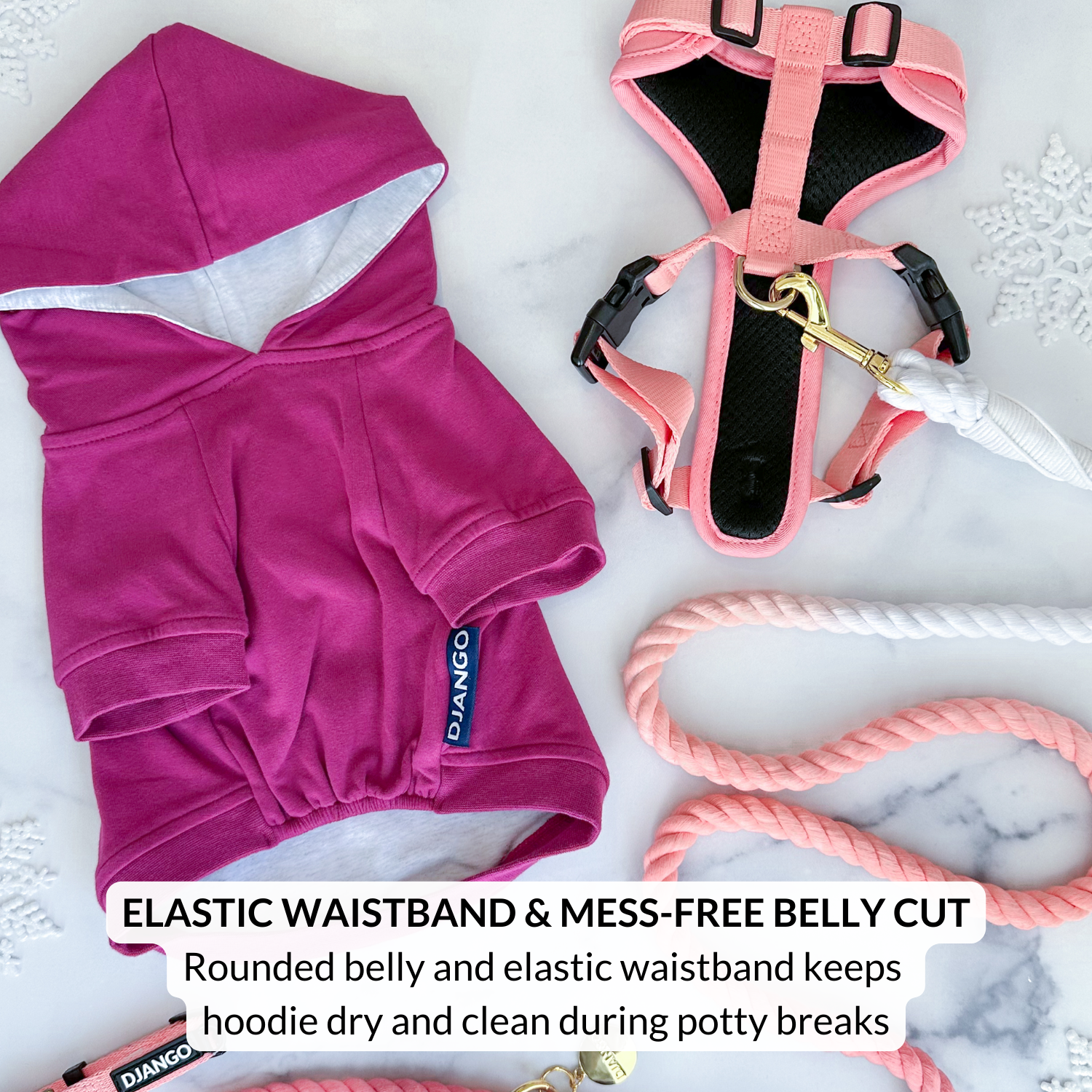 Pink dog hoodie with elastic waistband and mess-free belly cut, placed on a marble surface.