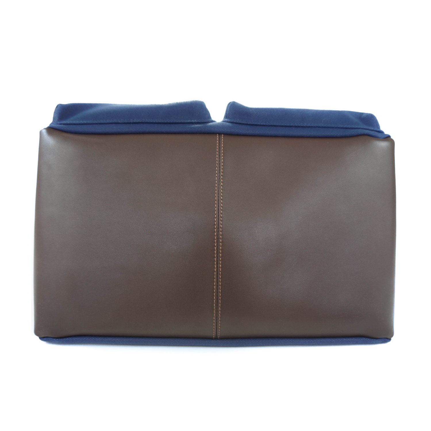Brown leather base of a dog carrier tote bag and stylish pet purse with navy blue canvas exterior on a white background