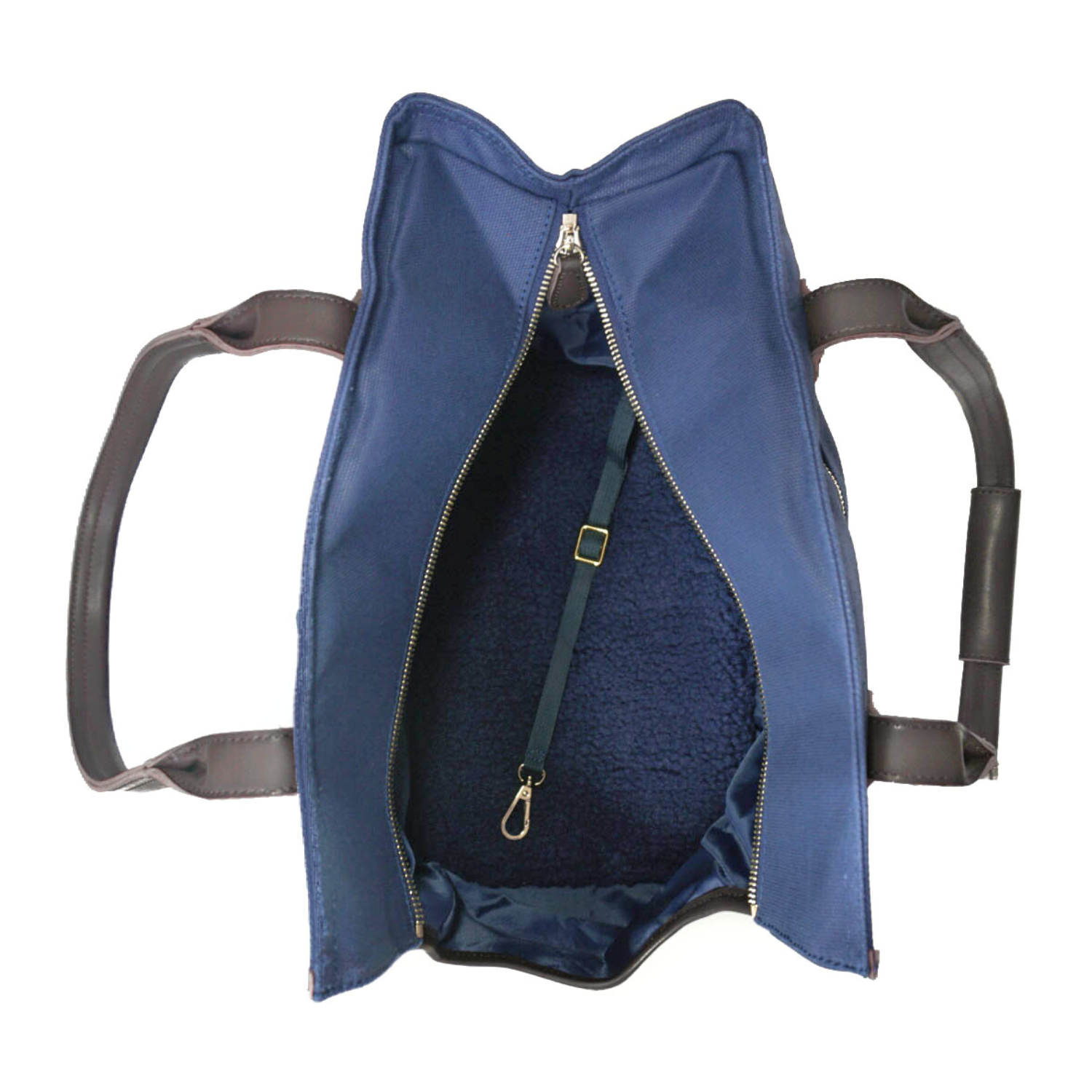 Interior view of a navy blue canvas dog carrier tote bag and pet purse showing a safety leash, brown leather handles, water-resistant and silky lining, and a plush and supportive sherpa bed for pets