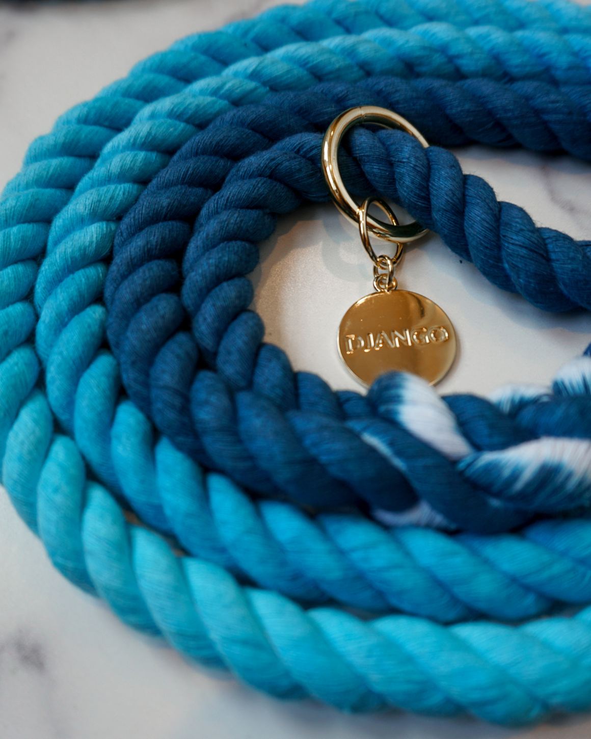 DJANGO Pacific Blue Cotton Rope Dog Leash - You and your dog will be the most stylish ones on the sidewalk with this handcrafted and hand-dyed green ombré cotton rope leash. Crafted from soft and flexible three-strand natural cotton rope, the rope leashes are hand-spliced and the ends whipped, resulting in an incredibly strong yet effortlessly chic and comfortable dog lead. Gold hardware adds additional sophistication to the stylish dog lead. Leash length measures 5 feet (152 cm) - djangobrand.com