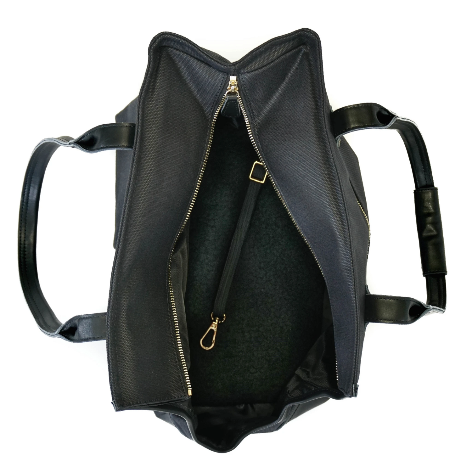 Interior of black waxed canvas dog carrier purse showing soft dog bed and safety leash