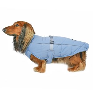 DJANGO's Whistler Winter Dog Coat is a warm and comfortable cold weather dog parka. Insulated for the coldest winter weather, this alpine-inspired puffer dog coat features a windproof and water-repellent exterior, a soft and cozy interior lining, and reflective piping for low light adventures. An adjustable webbing chest strap and velcro neck closure allow for easy on-off and a tailored fit around your dog's body.
